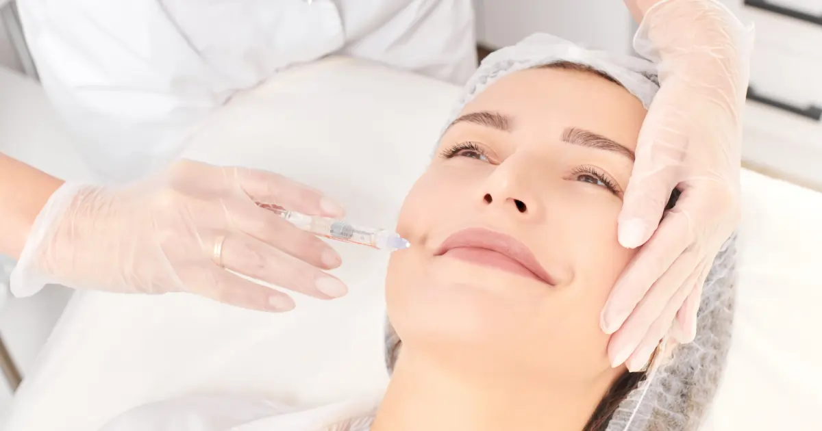 Smiling woman receiving dermal filler injection in Murrysville, PA